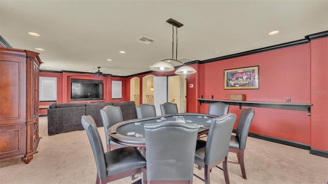 dining space featuring arched walkways, light carpet, crown molding, and visible vents