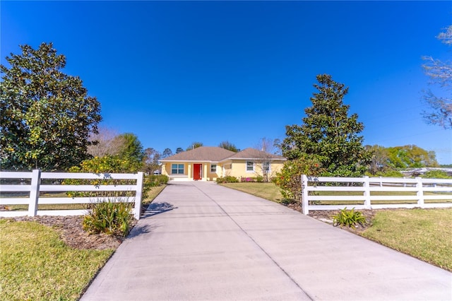 view of front facade with a fenced front yard and concrete driveway