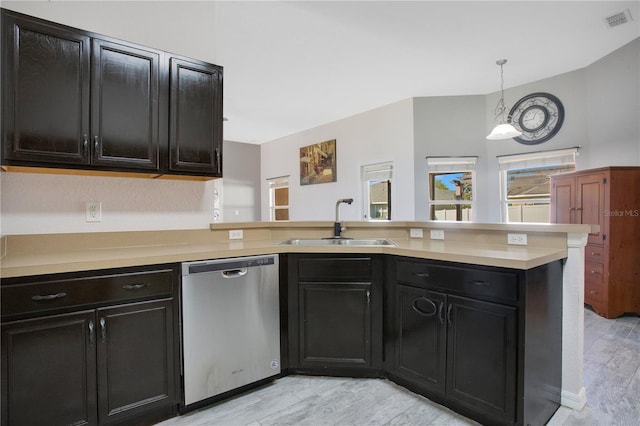 kitchen featuring visible vents, a peninsula, a sink, light countertops, and stainless steel dishwasher