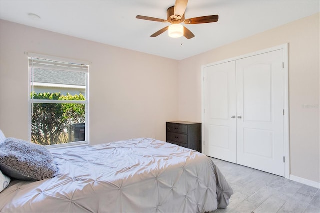 bedroom with a closet, baseboards, and a ceiling fan