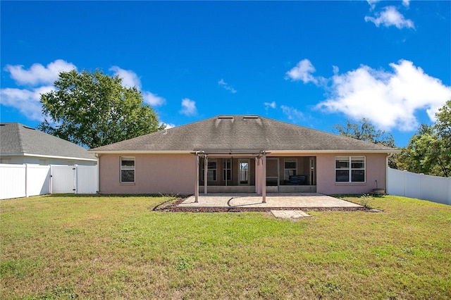 back of house with a patio area, a yard, a fenced backyard, and a gate