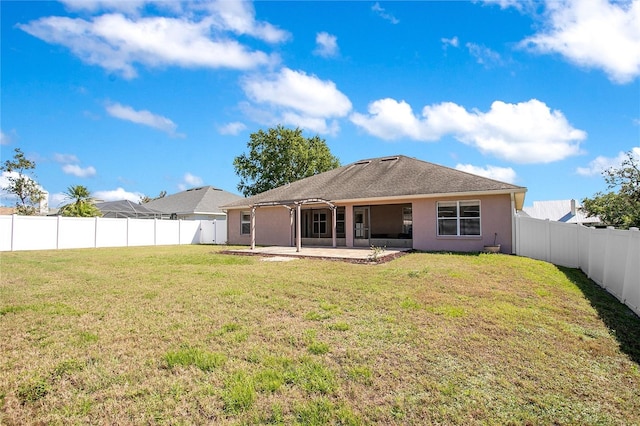 back of house featuring a patio area, a lawn, a fenced backyard, and stucco siding