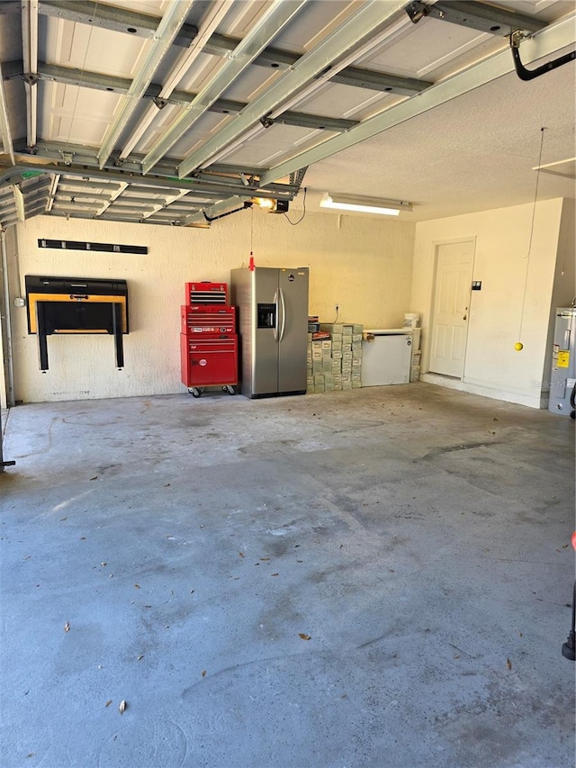 garage featuring a garage door opener, stainless steel fridge with ice dispenser, and water heater