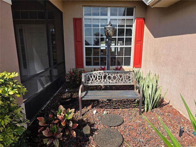 view of exterior entry with stucco siding