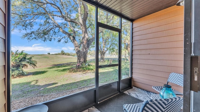 unfurnished sunroom featuring wood ceiling