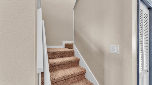 stairs with carpet flooring and baseboards