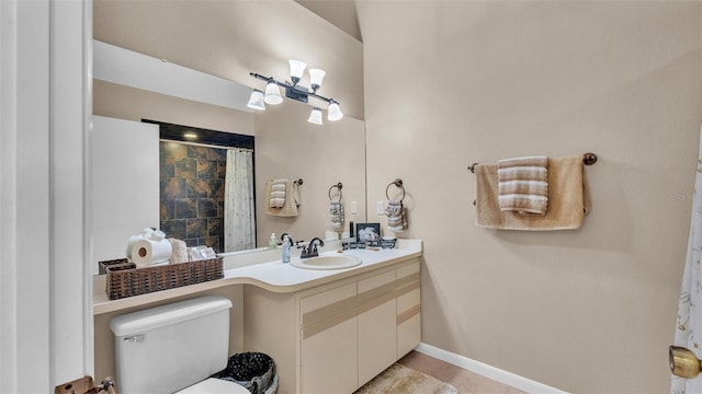 full bathroom with baseboards, toilet, curtained shower, tile patterned flooring, and vanity