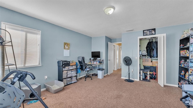 carpeted home office featuring visible vents and baseboards