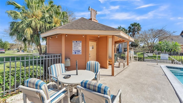 view of patio with fence and a community pool