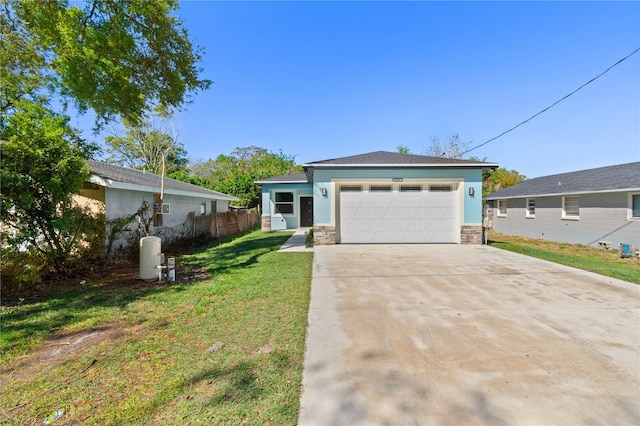 view of front of house featuring concrete driveway, a front yard, stucco siding, a garage, and stone siding