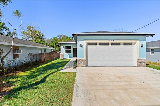 view of front of house with a front lawn, stucco siding, a garage, stone siding, and driveway