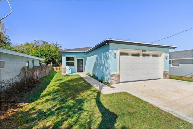 mid-century inspired home featuring a front lawn, fence, stucco siding, driveway, and an attached garage