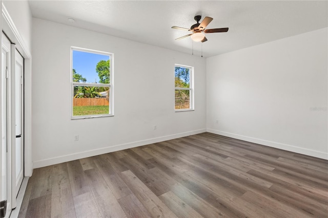 unfurnished bedroom featuring a ceiling fan, baseboards, and wood finished floors