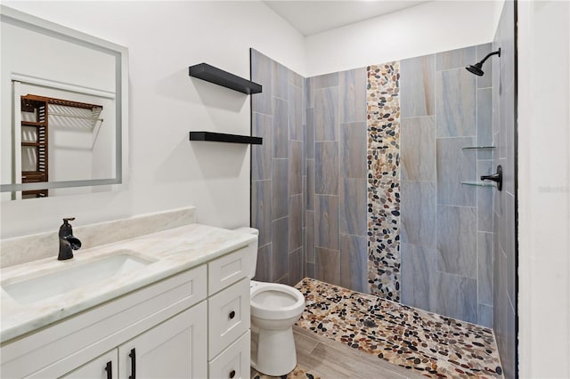 full bath with vanity, toilet, wood finished floors, and a shower stall