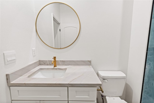 bathroom with toilet and vanity