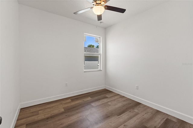 empty room featuring a ceiling fan, baseboards, and wood finished floors