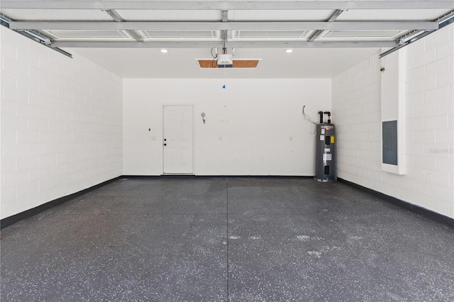 garage with concrete block wall, a garage door opener, and water heater