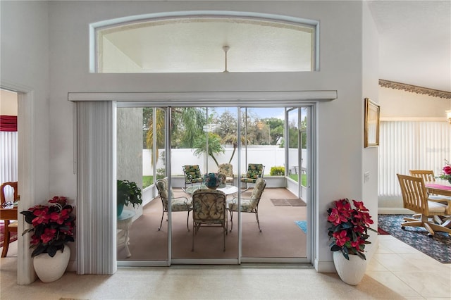 tiled dining space featuring a high ceiling