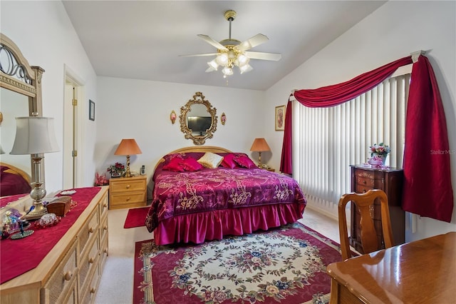 carpeted bedroom featuring lofted ceiling and ceiling fan