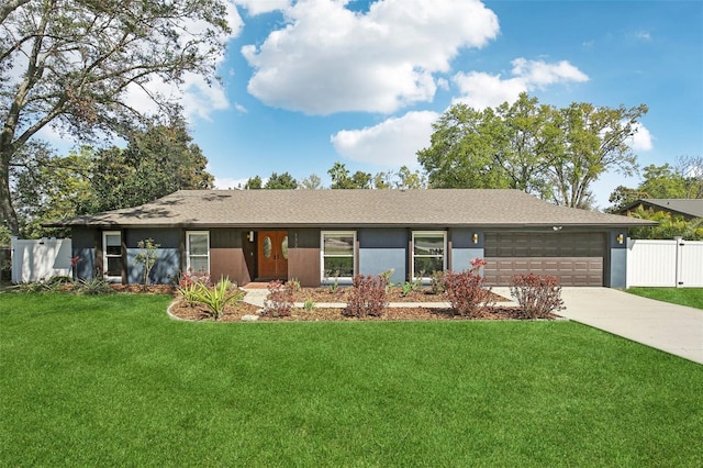 ranch-style house featuring concrete driveway, fence, a front lawn, and stucco siding