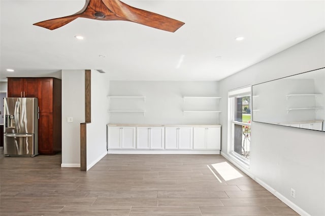 spare room with light wood finished floors, baseboards, a ceiling fan, and recessed lighting