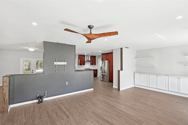 unfurnished living room featuring baseboards, a ceiling fan, wood finished floors, french doors, and recessed lighting