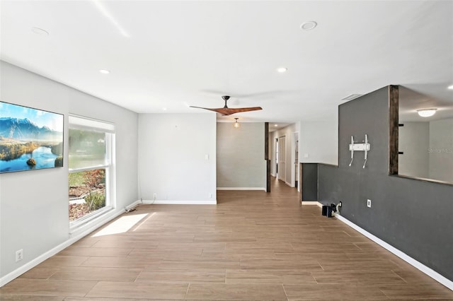 unfurnished living room featuring wood finish floors, ceiling fan, baseboards, and recessed lighting