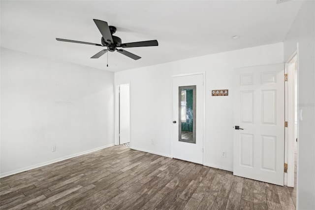 unfurnished room featuring baseboards, a ceiling fan, and wood finished floors