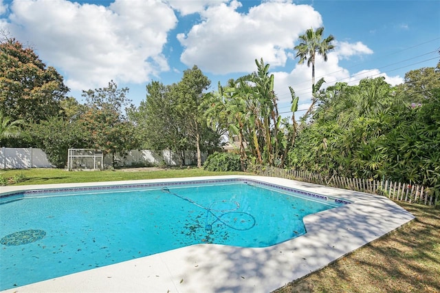 view of pool with a fenced backyard, a lawn, and a fenced in pool