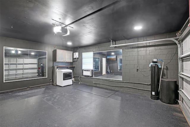 garage with concrete block wall, an AC wall unit, and a garage door opener