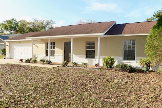 single story home with a garage, concrete driveway, brick siding, and a shingled roof