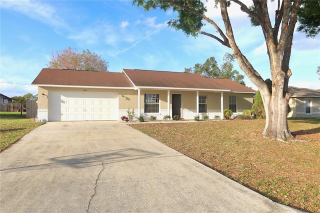 ranch-style house featuring brick siding, stucco siding, an attached garage, a front yard, and driveway