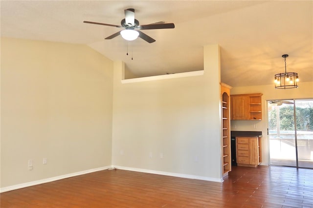 spare room featuring baseboards, vaulted ceiling, and dark wood-type flooring