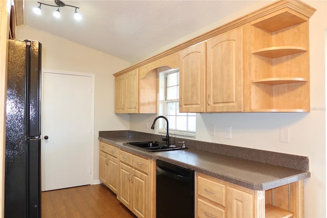 kitchen featuring open shelves, dark countertops, light brown cabinets, a sink, and black appliances