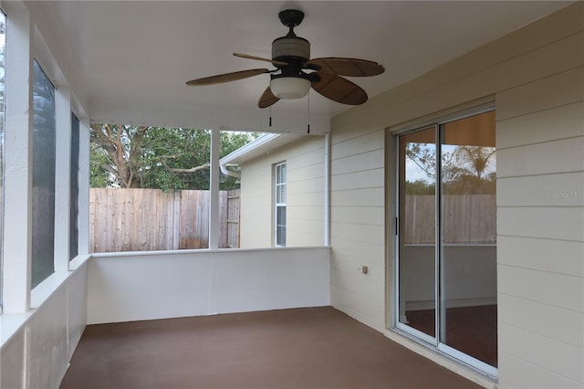 unfurnished sunroom featuring a ceiling fan