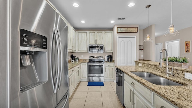 kitchen featuring pendant lighting, light tile patterned floors, stainless steel appliances, recessed lighting, and a sink