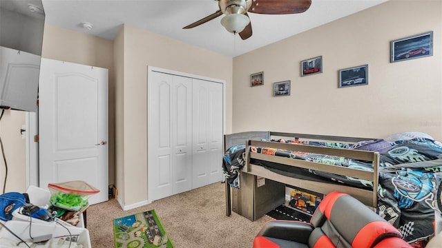 bedroom featuring baseboards, a closet, a ceiling fan, and light colored carpet
