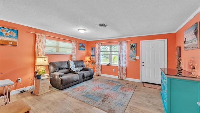 living area with a textured ceiling, visible vents, baseboards, ornamental molding, and light wood finished floors