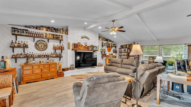 living room with a ceiling fan, lofted ceiling with beams, a bar, and wood finished floors