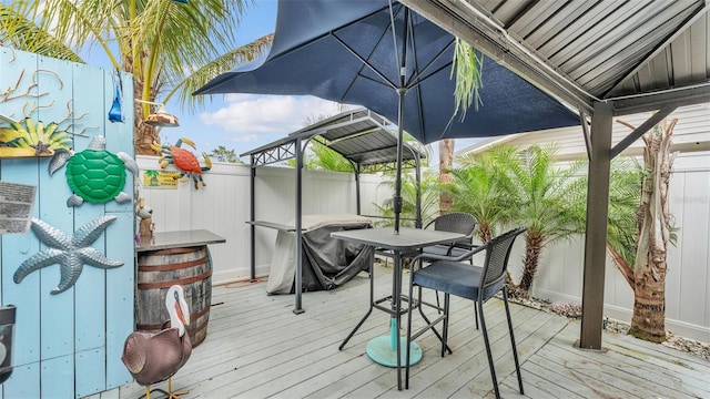 wooden terrace featuring fence and outdoor dining area