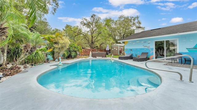 view of swimming pool featuring a patio area, a fenced backyard, a jacuzzi, and a fenced in pool