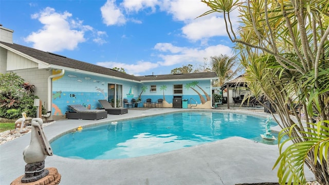 outdoor pool with a patio area and a gazebo