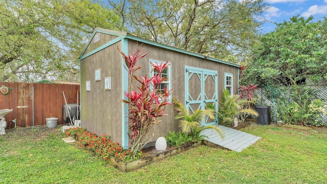 view of shed featuring fence