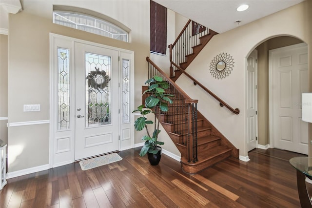 foyer with wood-type flooring and baseboards