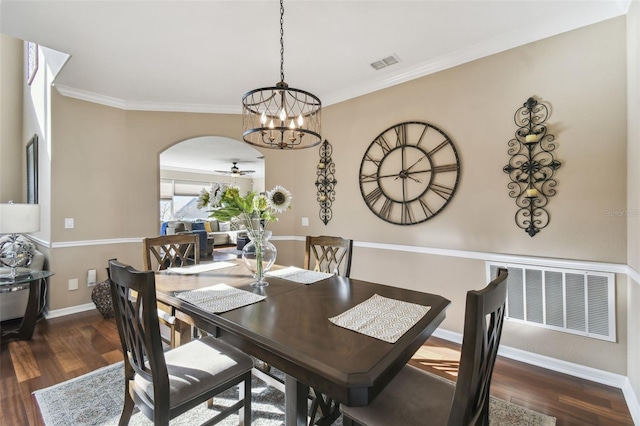 dining space featuring arched walkways, visible vents, baseboards, and wood finished floors