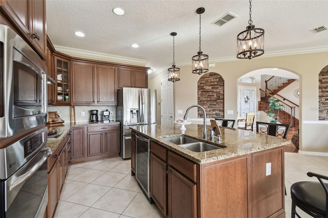 kitchen with light stone counters, wine cooler, crown molding, appliances with stainless steel finishes, and a sink