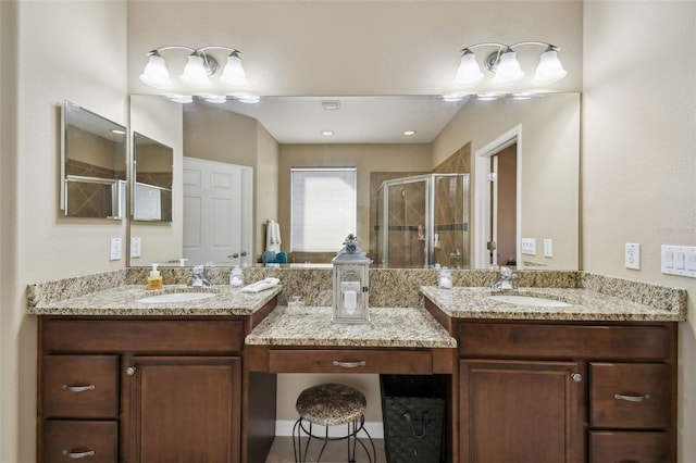 full bathroom with two vanities, a sink, and a shower stall