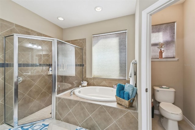 bathroom with baseboards, toilet, a shower stall, a bath, and recessed lighting