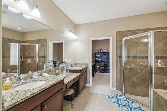 bathroom featuring a stall shower, tile patterned flooring, and a sink