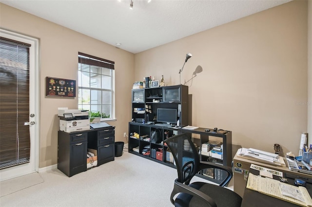 carpeted office space featuring baseboards